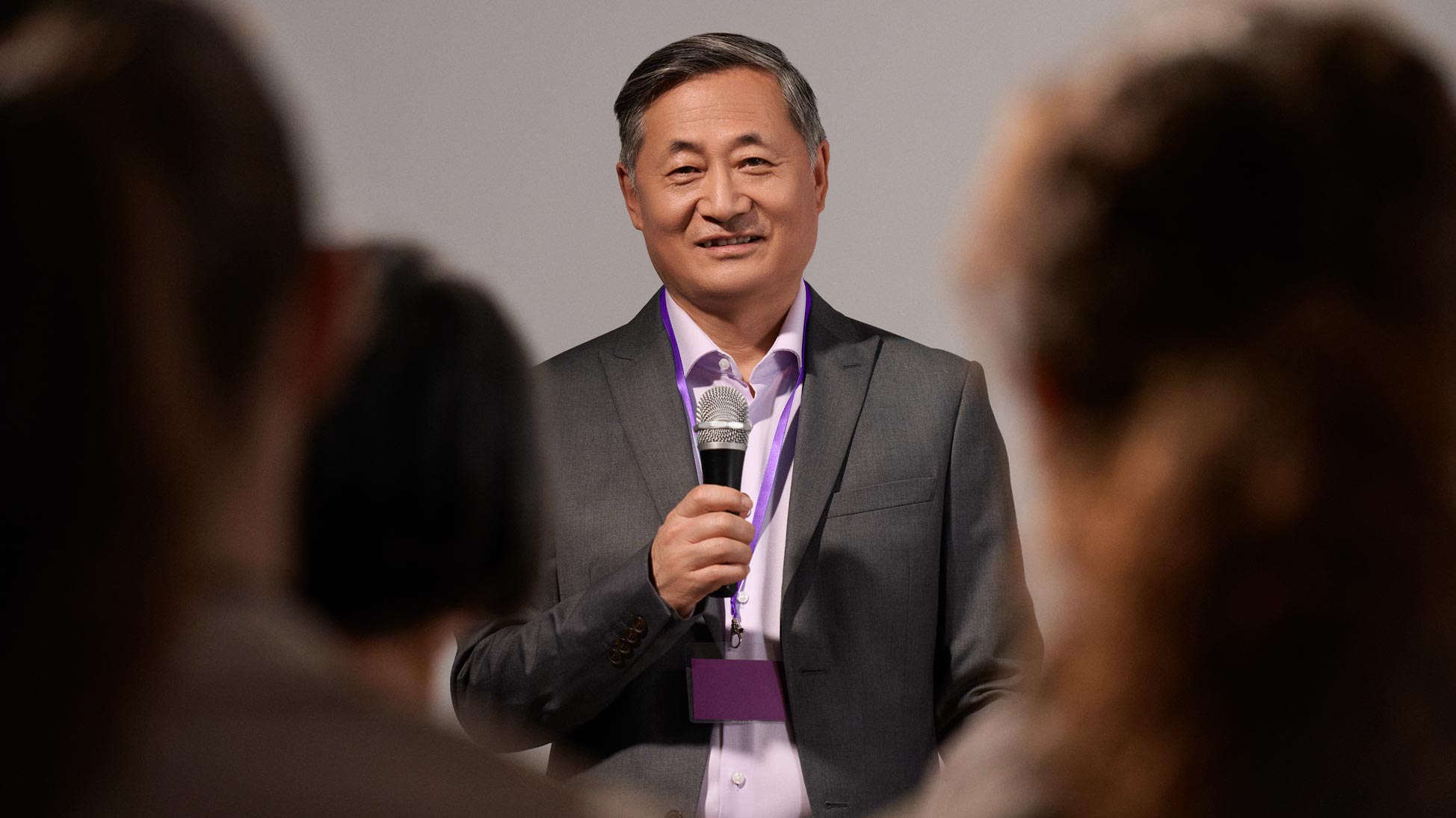 Confident man presenting, wearing hearing aids.