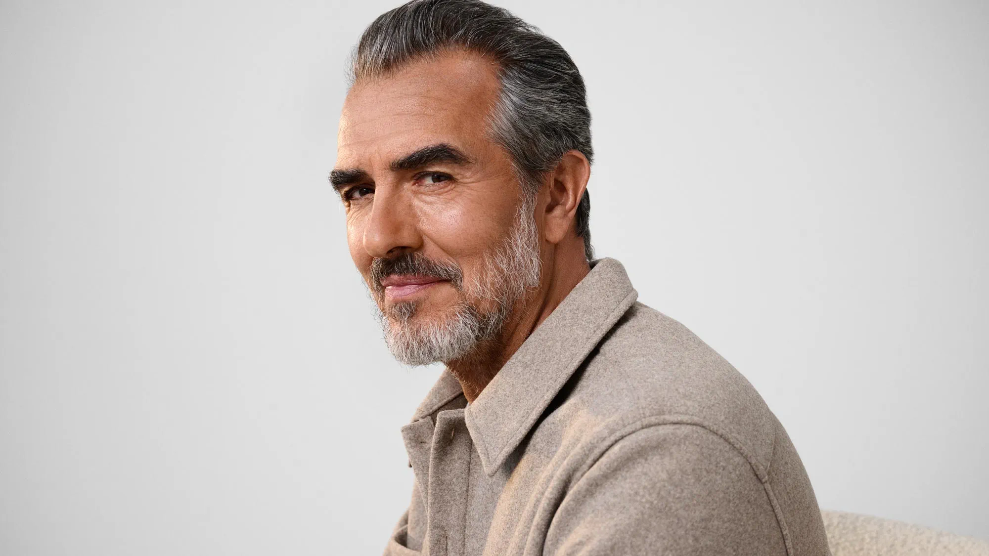 Man glancing, wearing hearing aids.
