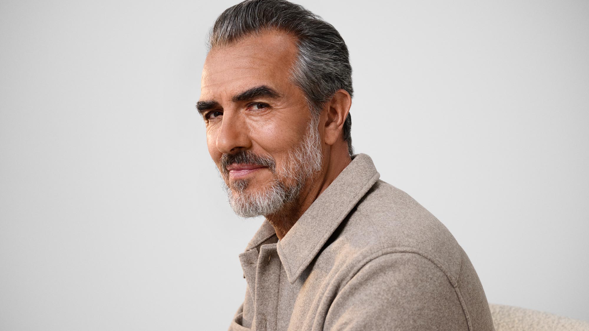 Man glancing, wearing hearing aids.