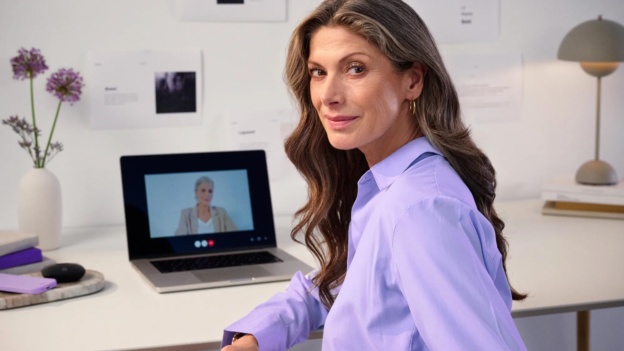 Woman in a virtual meeting, discussing hearing loss.