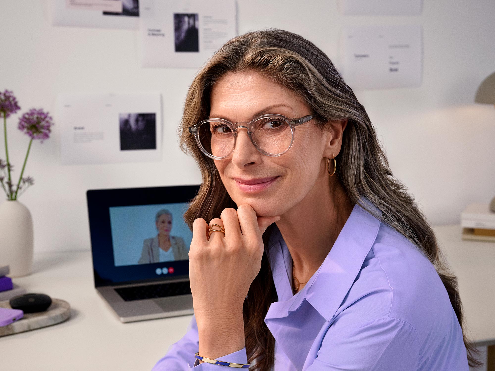 Woman contentedly working, showcasing hearing aids.
