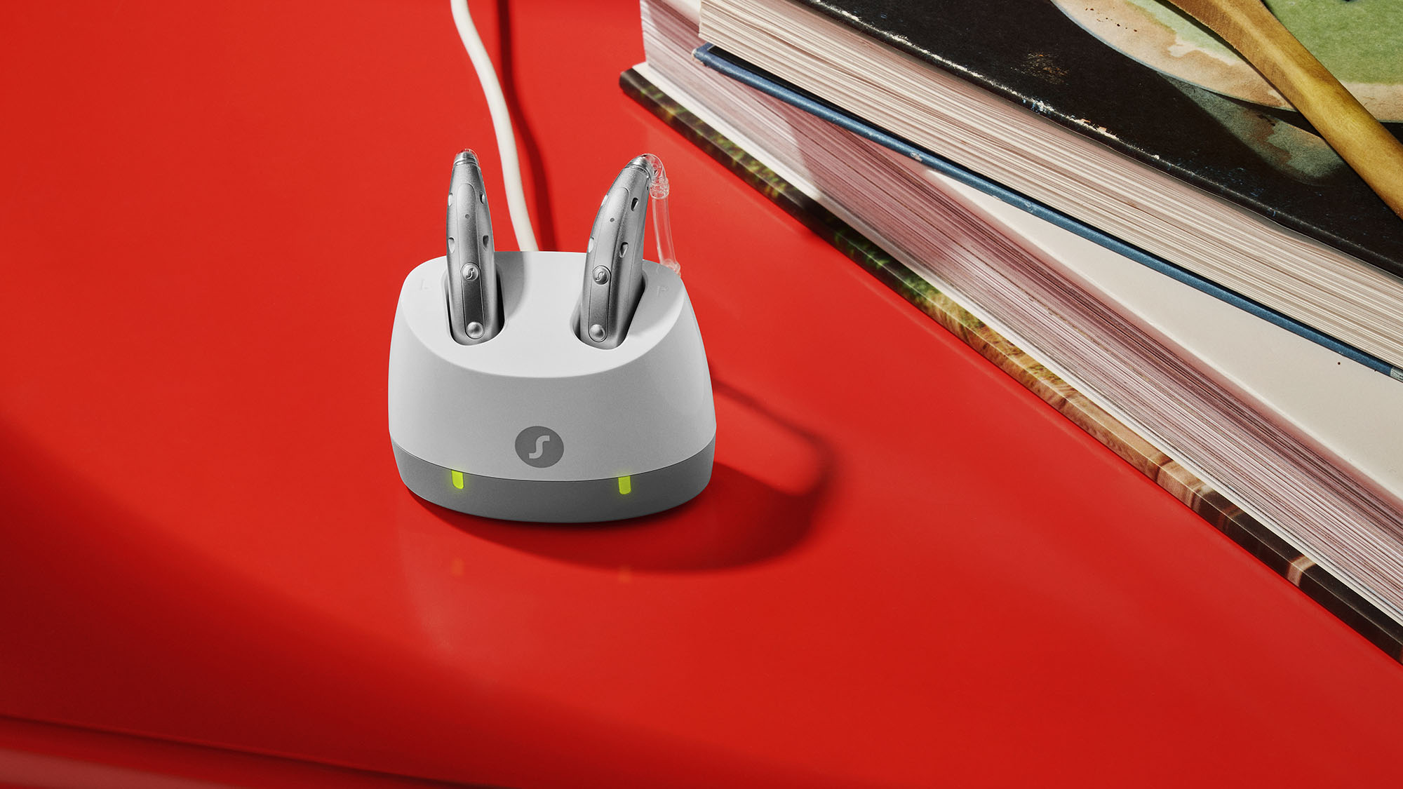 Signia Motion Charge&Go IX hearing aids placed in charger on table