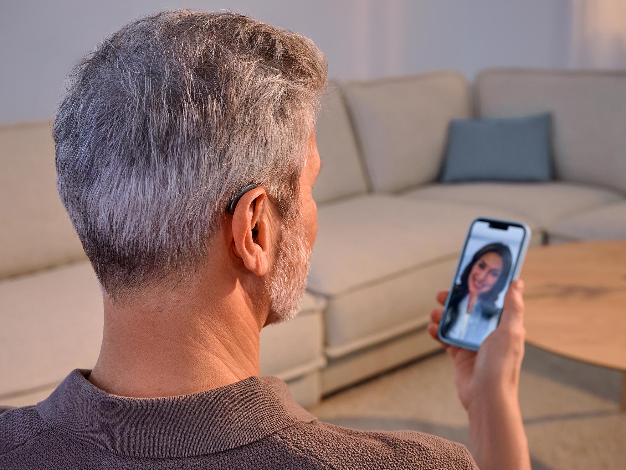 Man talking on the phone wearing Signia Pure hearing aids