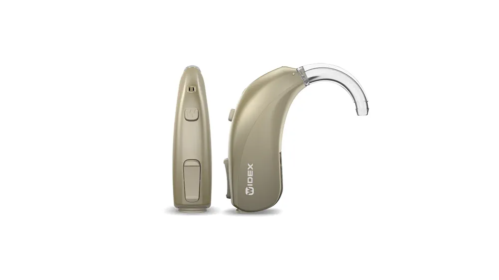 Widex moment behind the ear 13 D in a honey blonde colour, represented in a hand to show the true size of the hearing aid. 