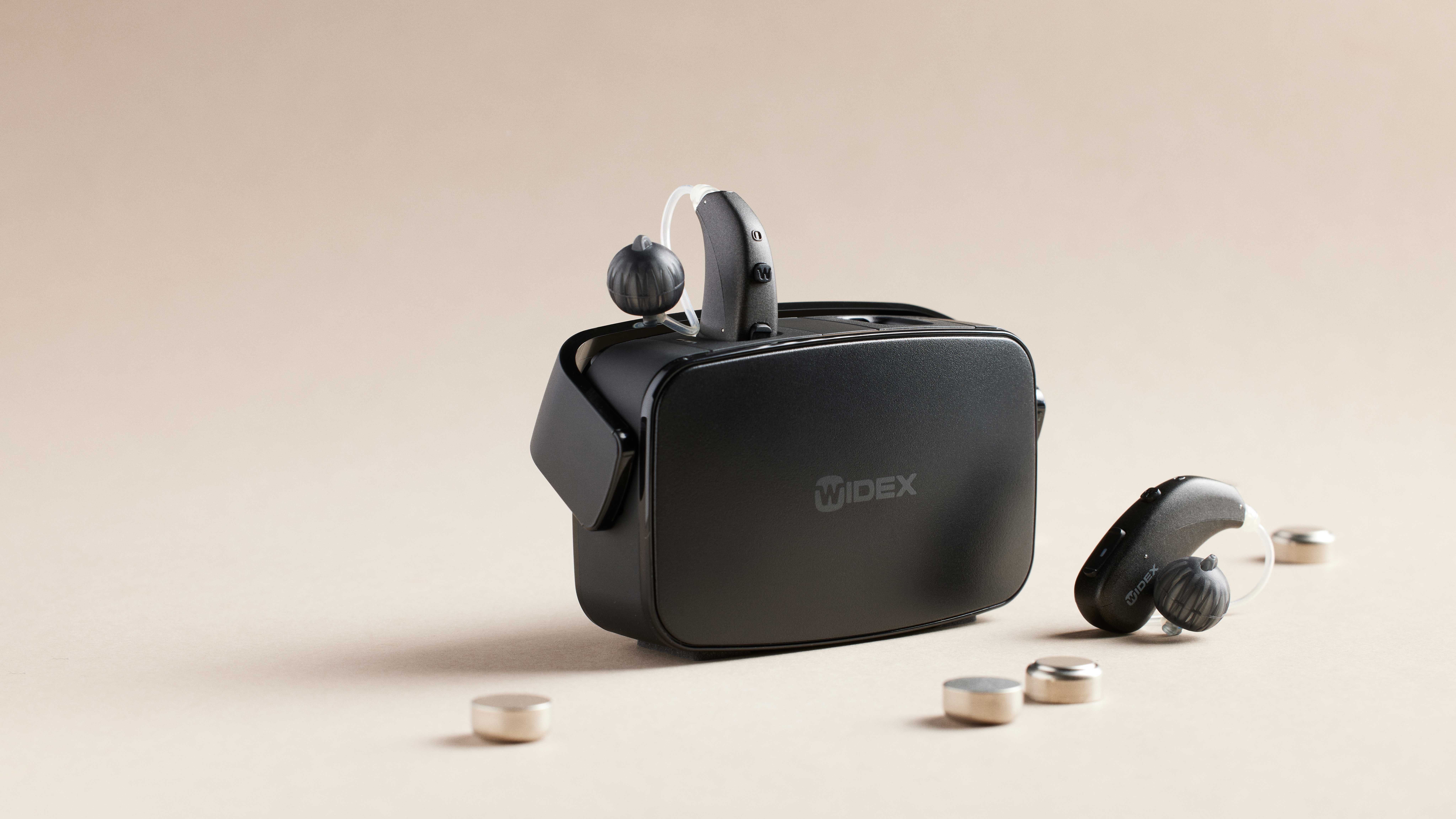Widex behind the ear RD hearing aids in its respectable charger. 