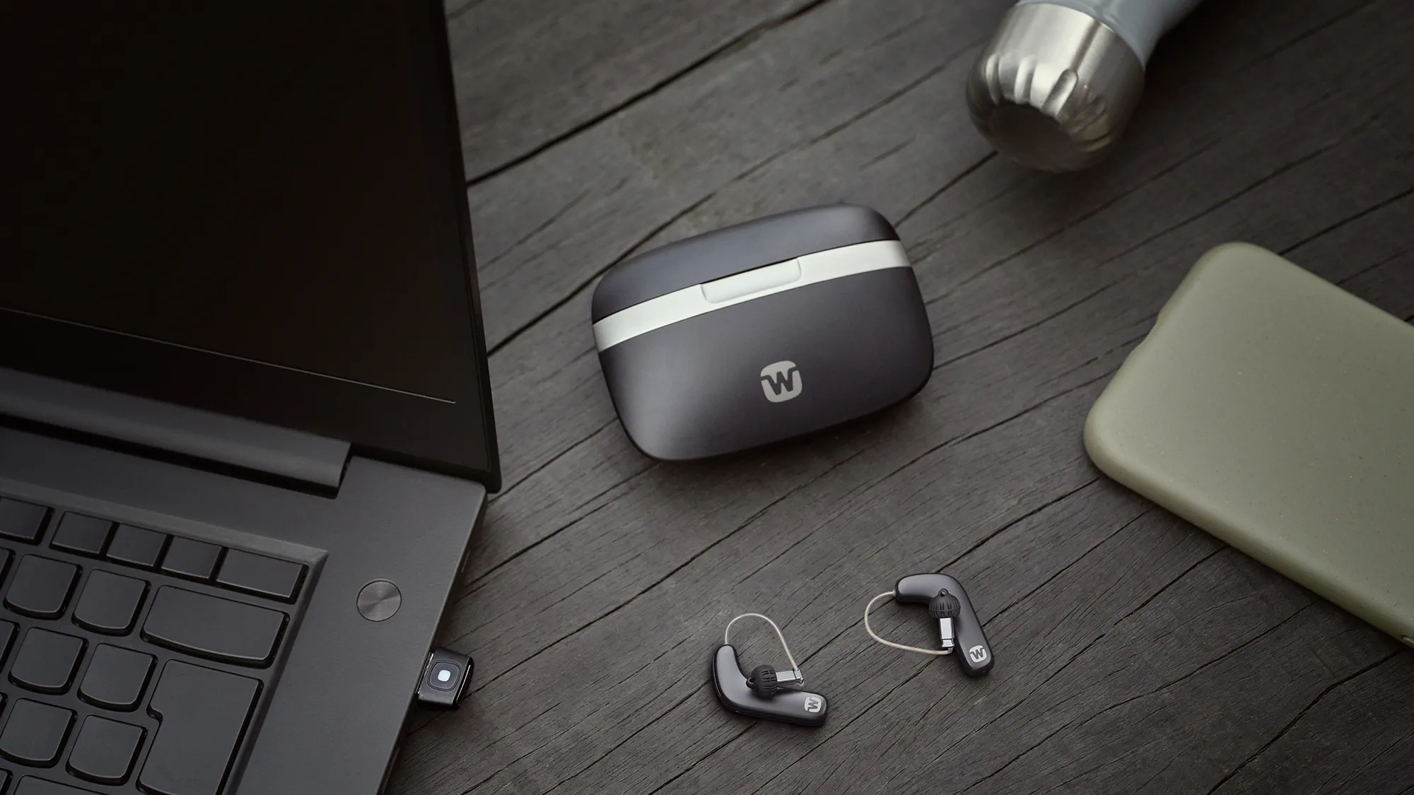 Widex Smart RIC shown next to charging case