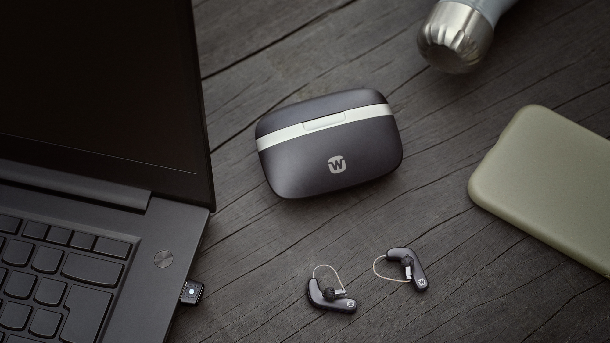 Widex Smart RIC shown next to charging case