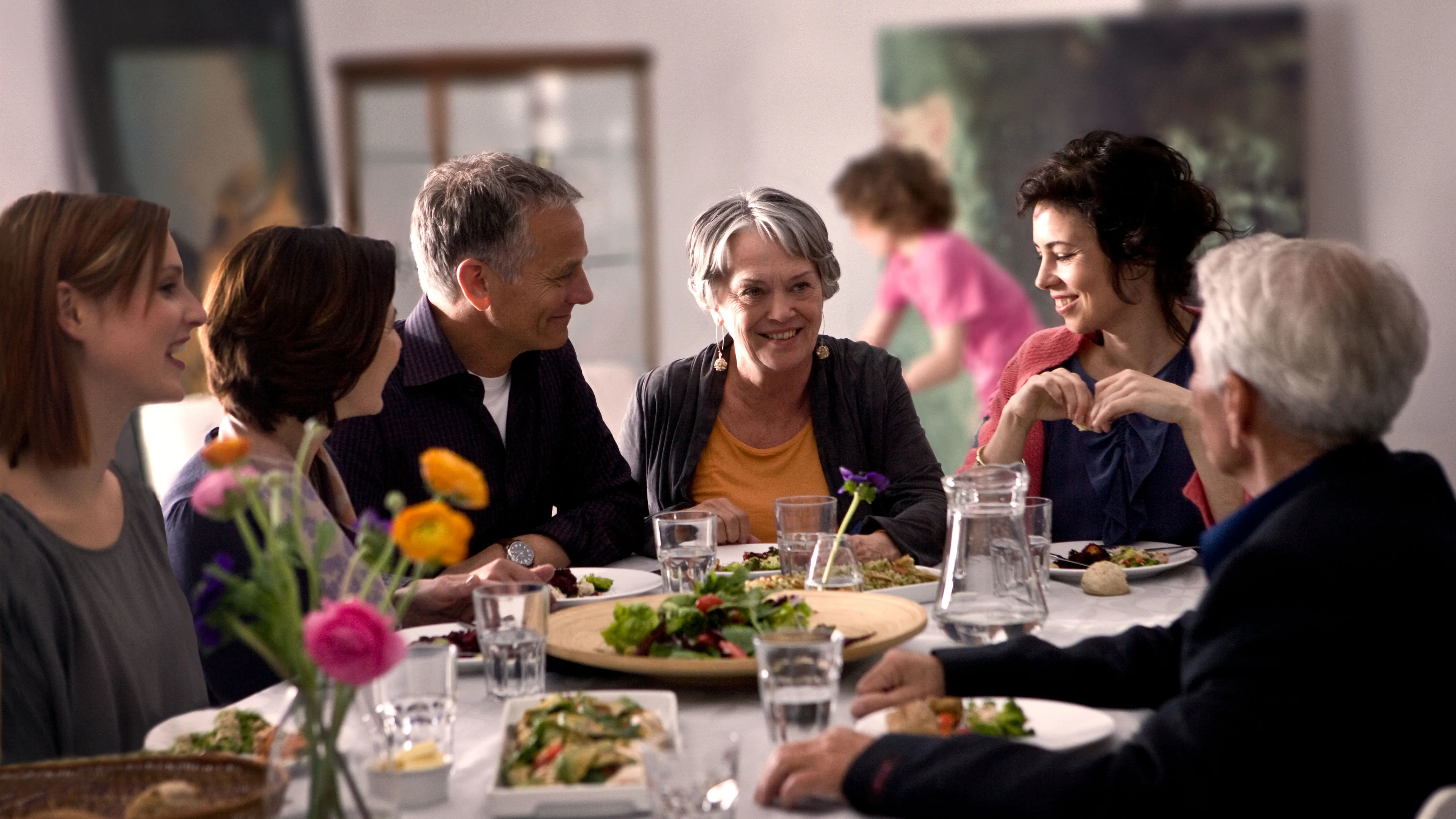 Family dinner where someone with hearing loss struggles to follow conversations.