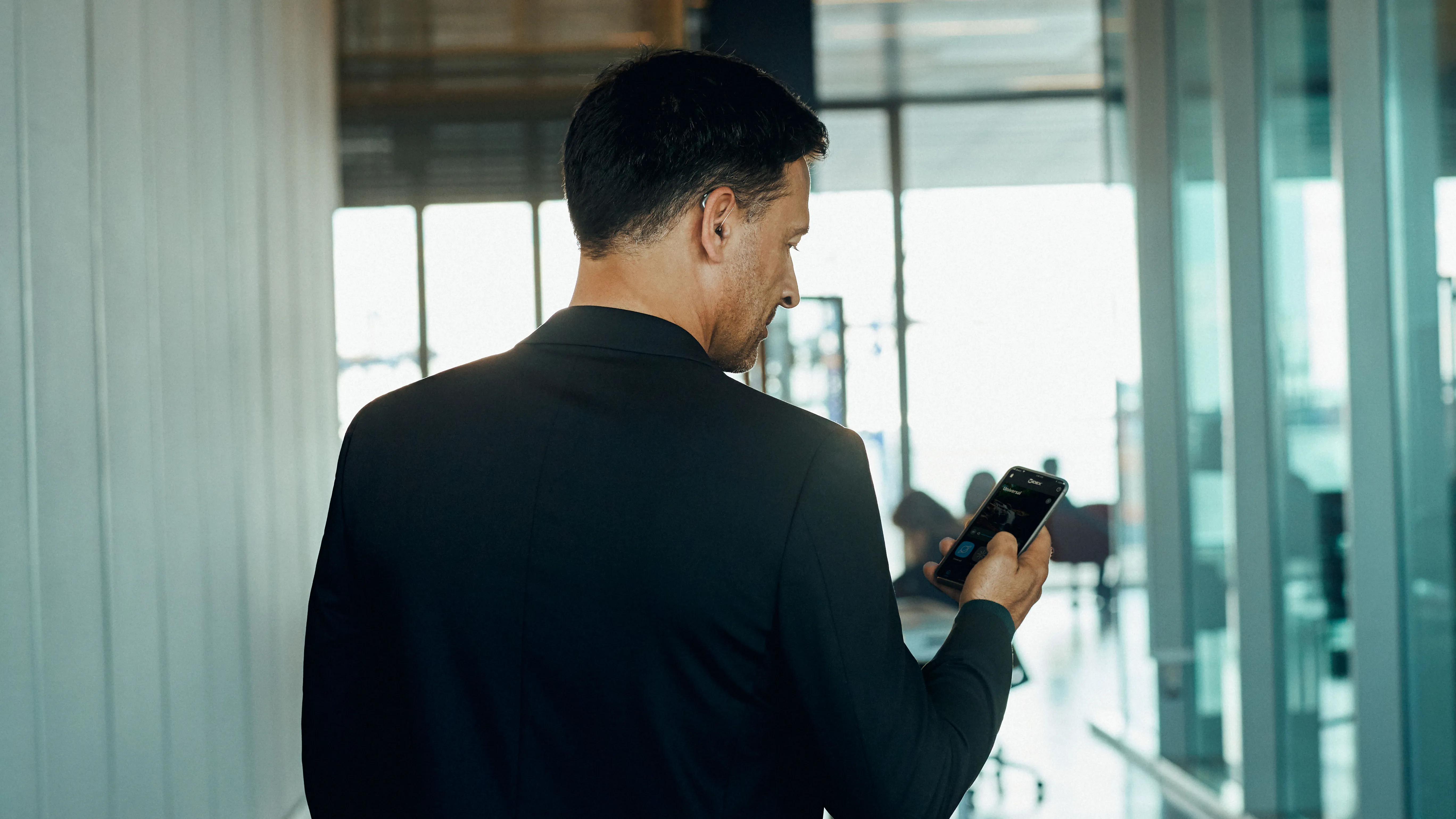 man in office answering phone with hearing aids