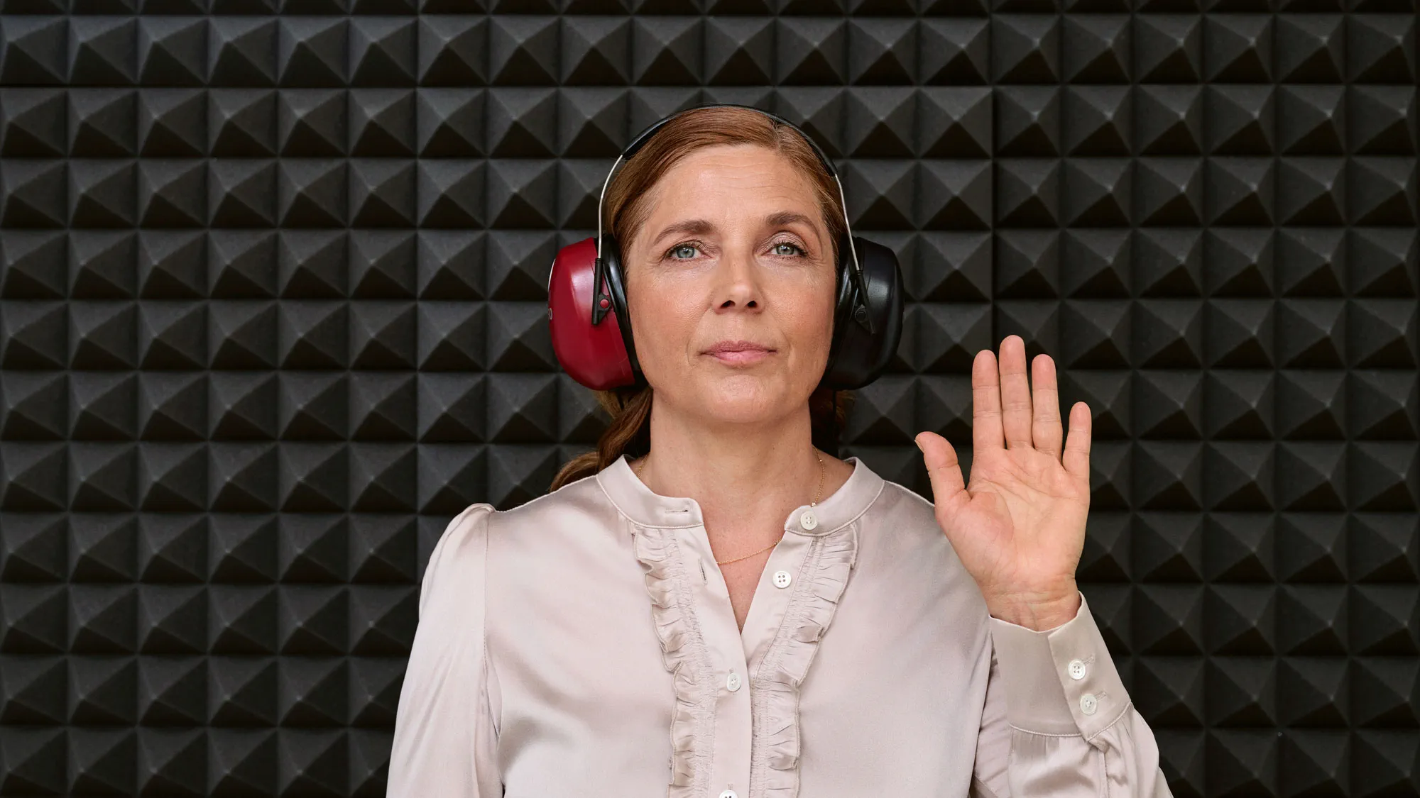 A customer getting a hearing test inside a sound booth during a hearing appointment.