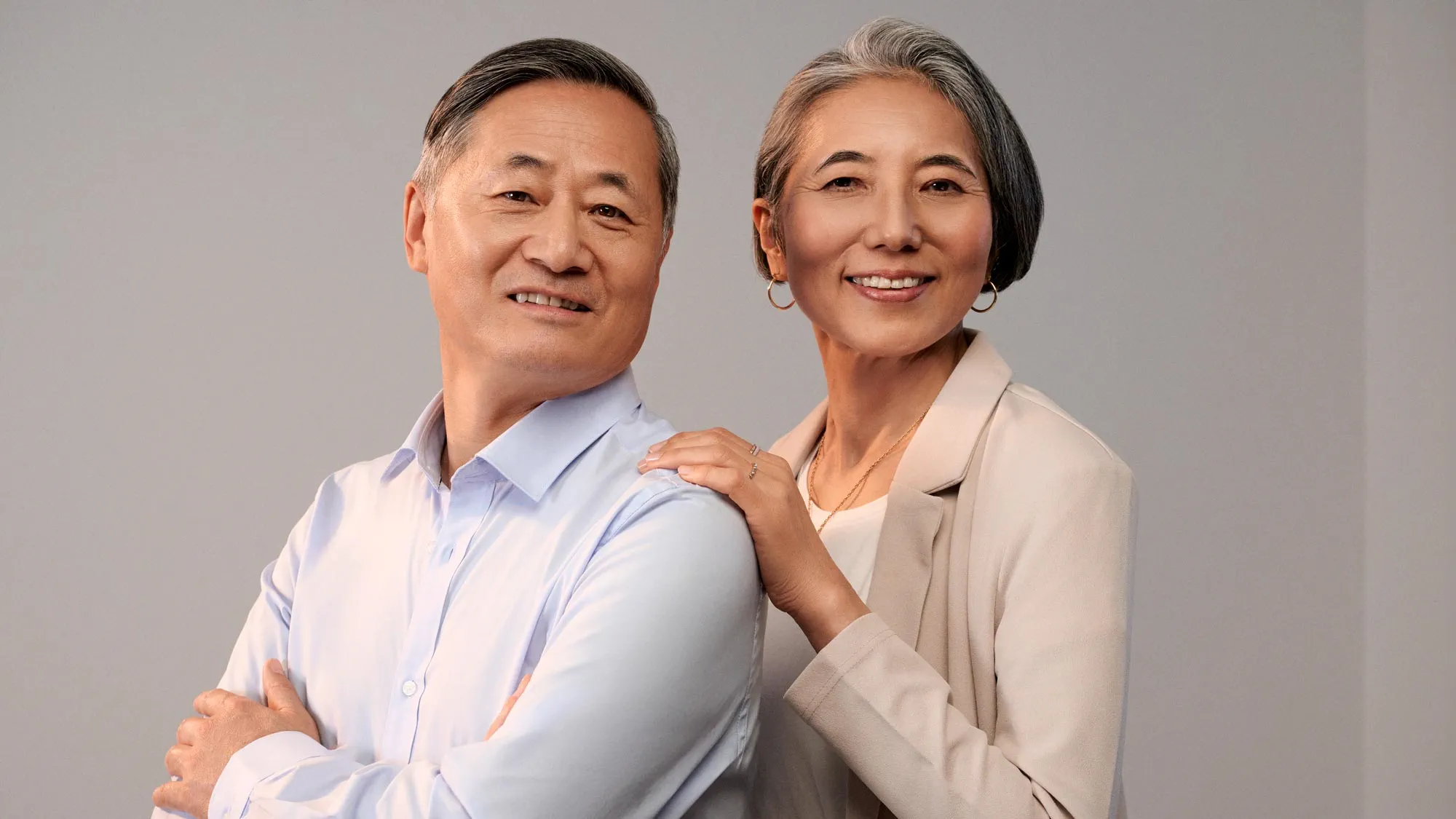 Couple smiling together, indicating hearing improvement.