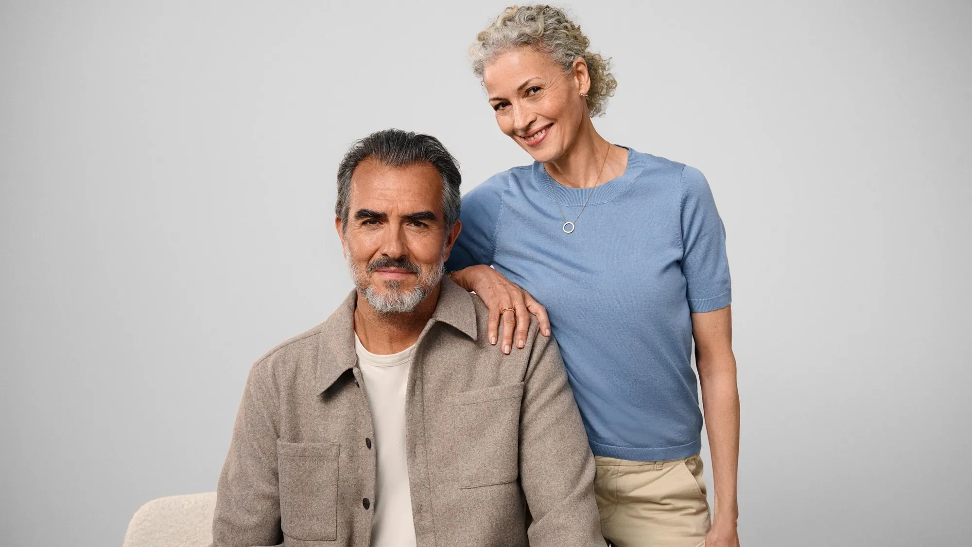 Couple standing together, indicating hearing improvement.