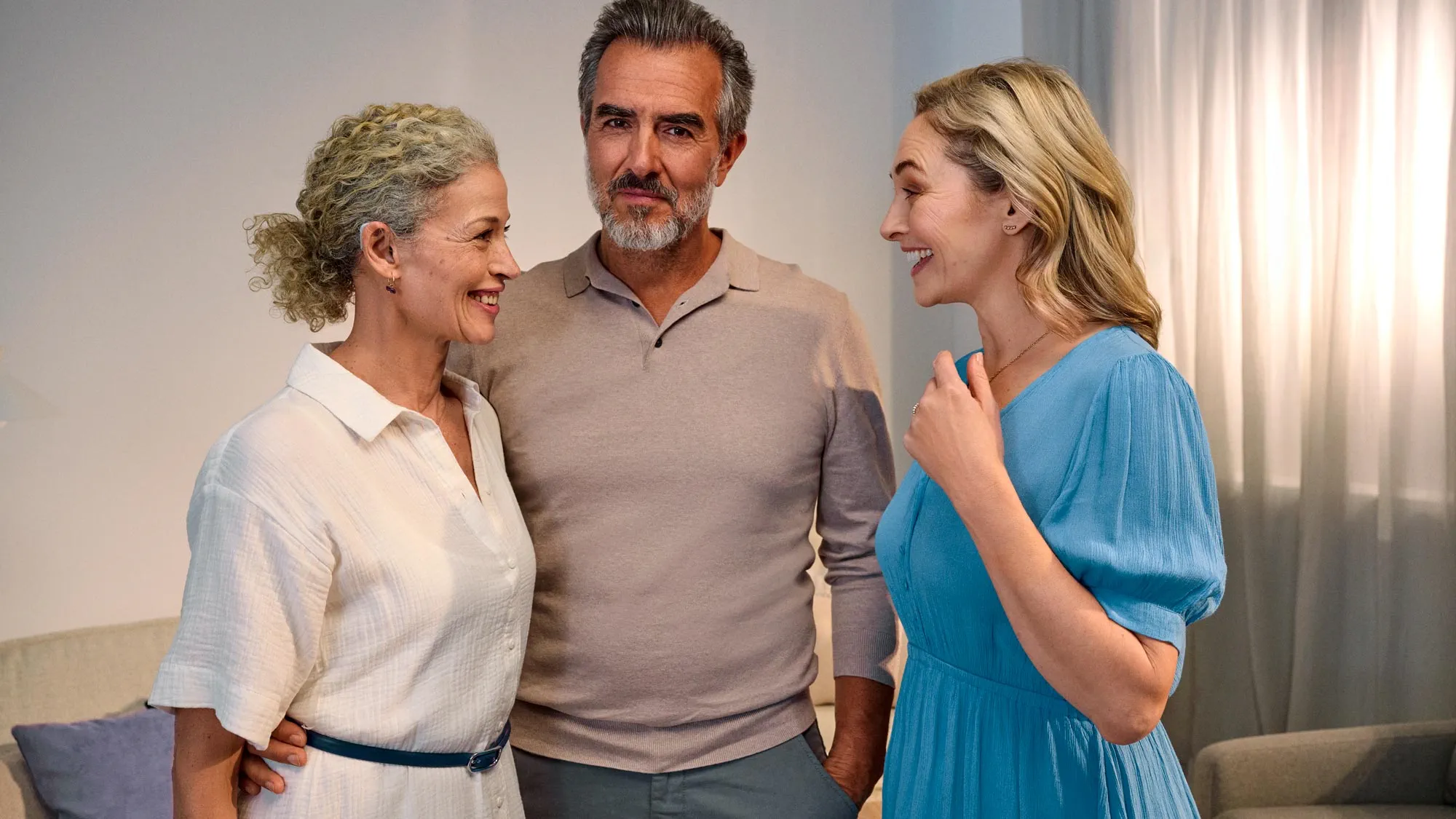 Friends conversing casually, discussing hearing improvement.