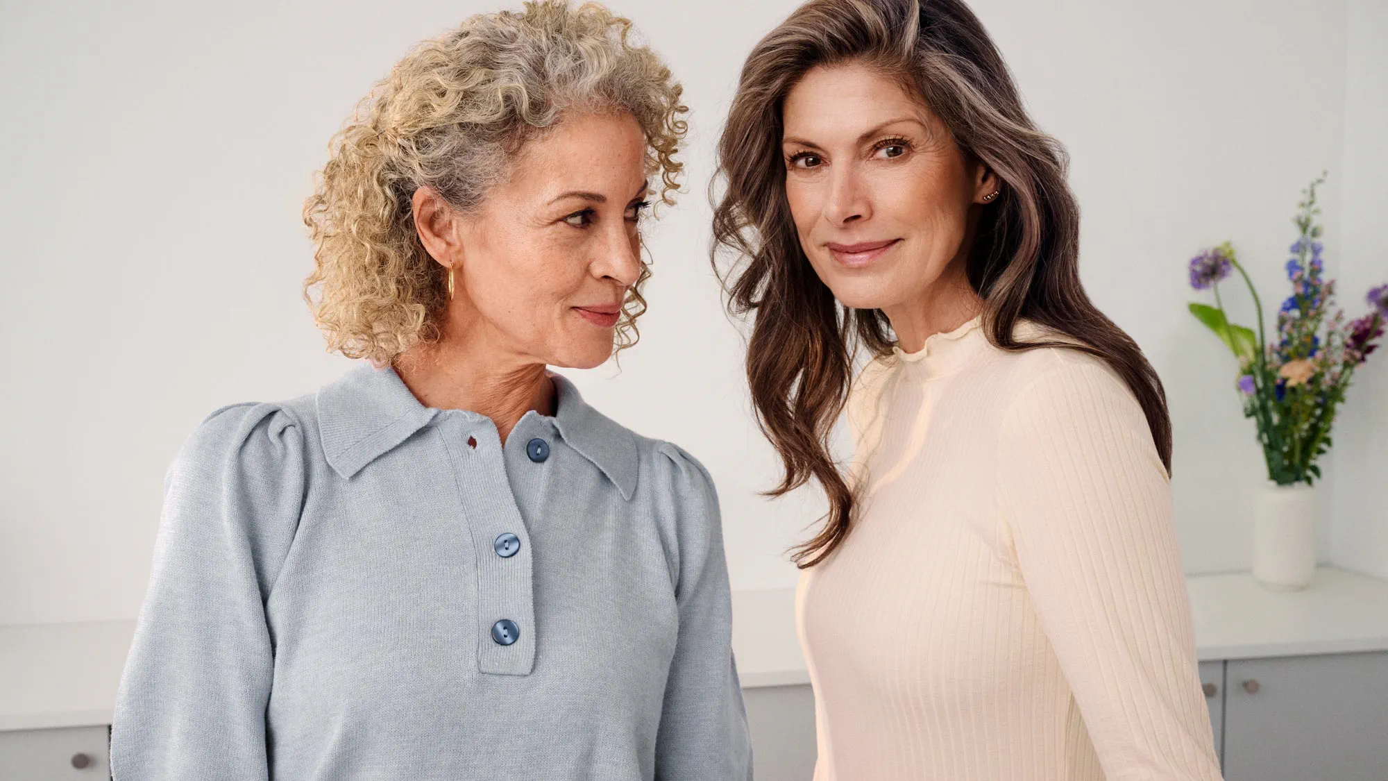 Powerful moment between friends, woman wearing hearing aids.