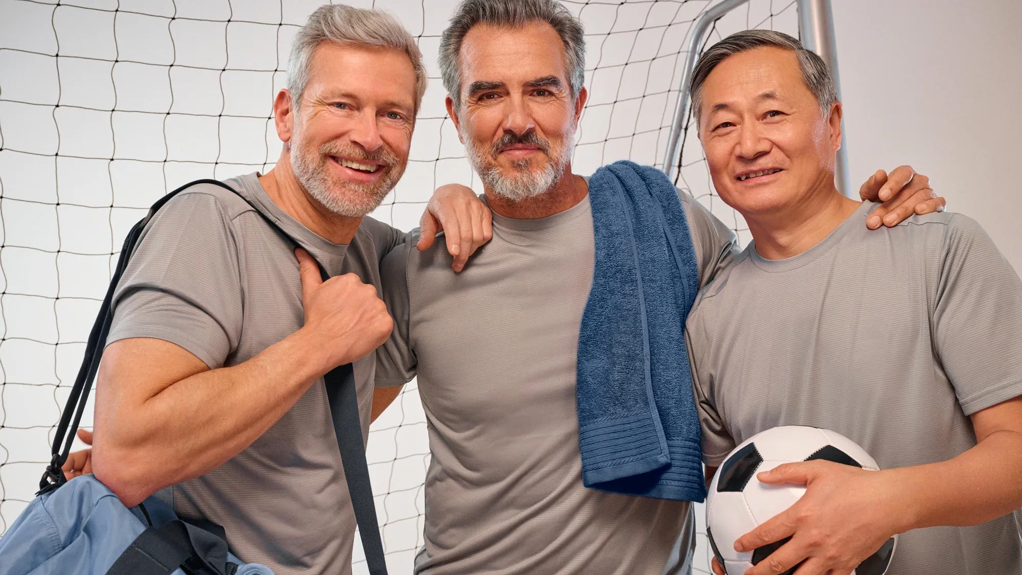 Portrait of friends playing soccer, showcasing hearing aids.