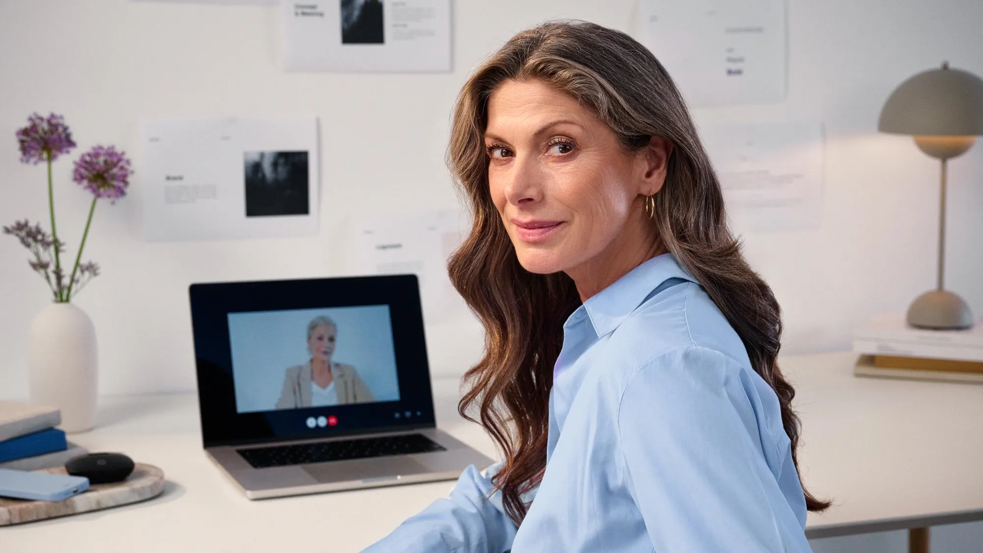 Woman in a virtual meeting, discussing hearing loss.