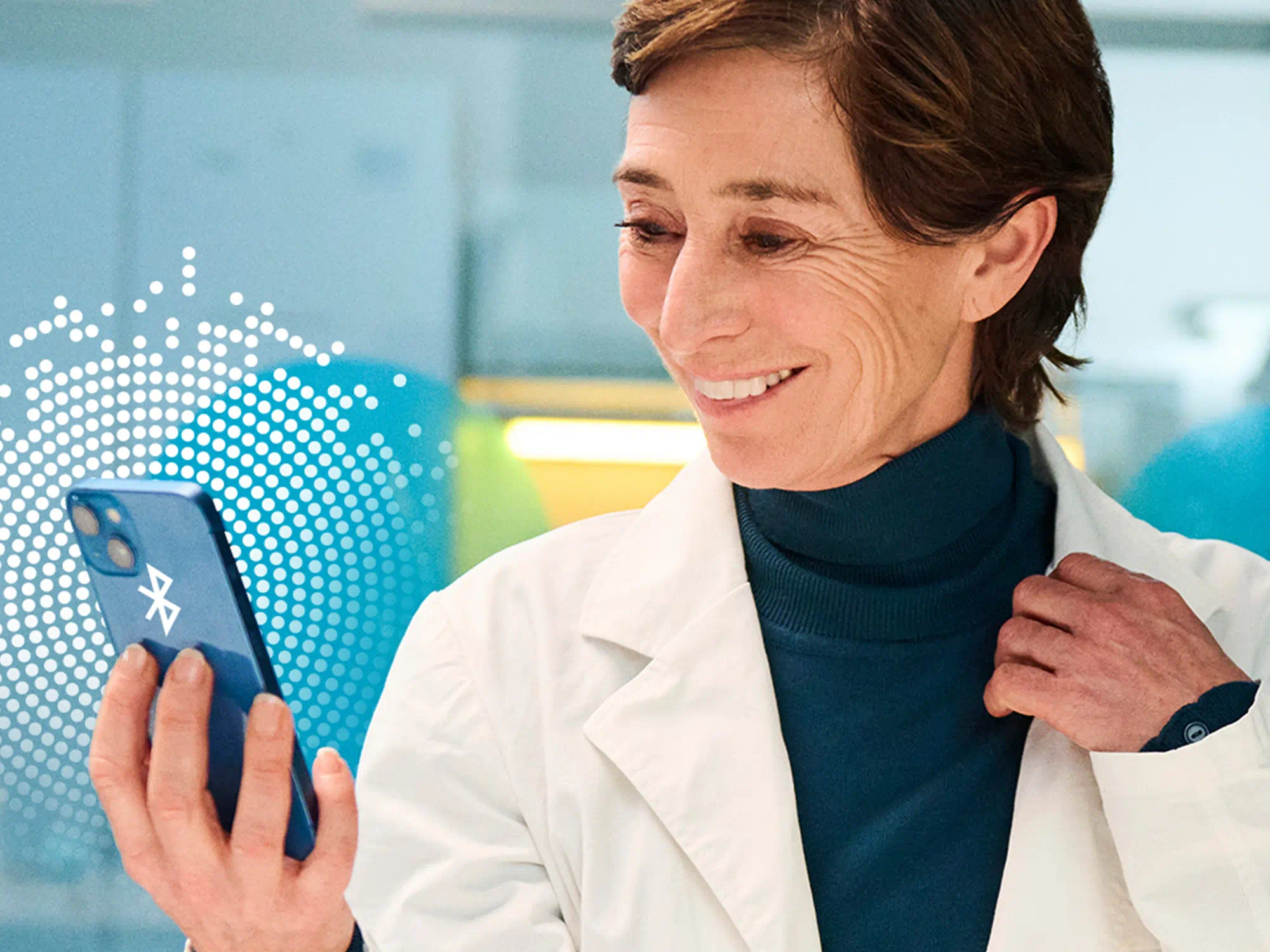 Scientist with hearing-loss using Bluetooth-enabled hearing-aids, highlighting tech integration in modern hearing solutions.