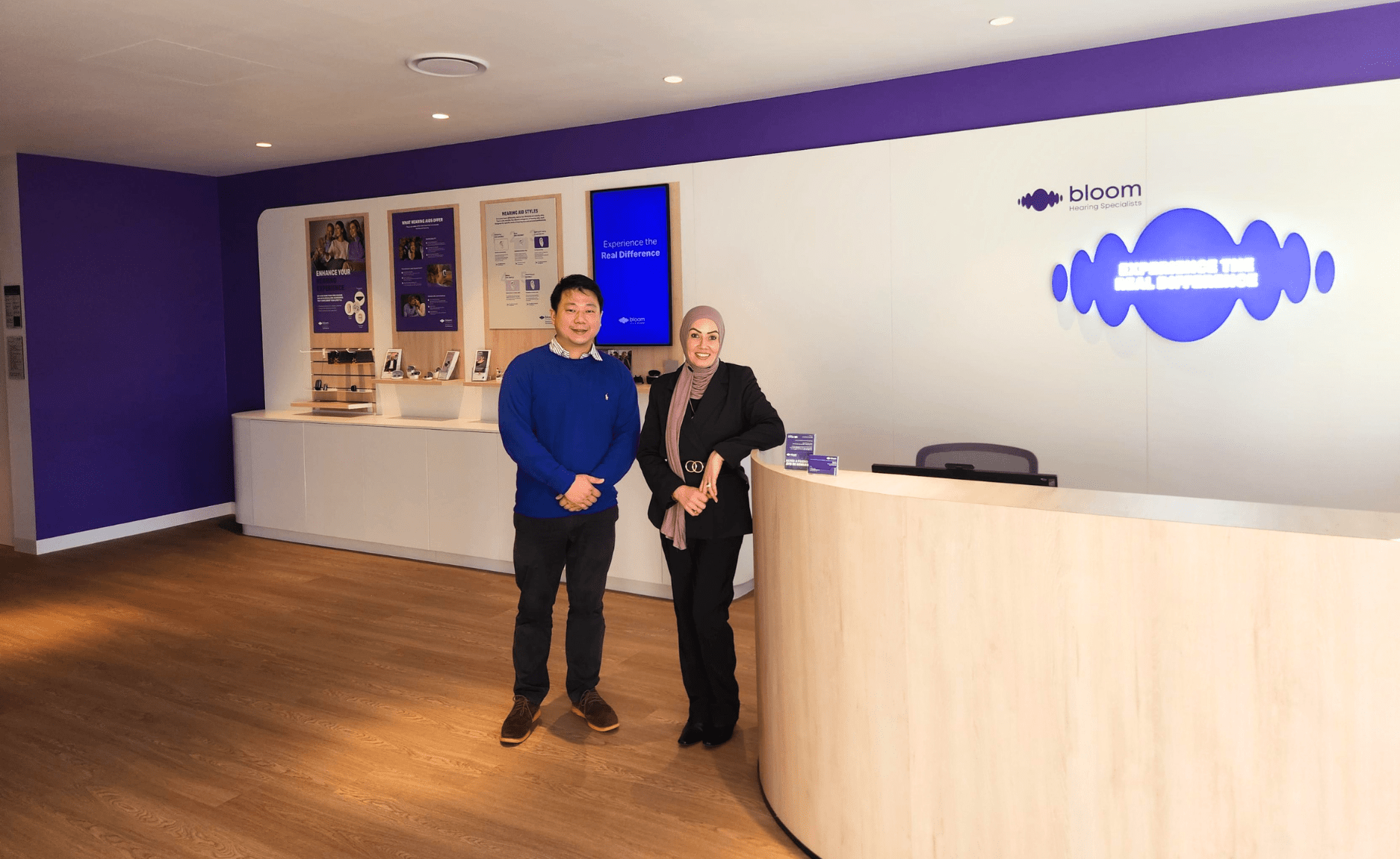 Nam Fan (Ivis) Ng and Fatimah Eid standing inside Bloom Hearing Specialists Warilla
